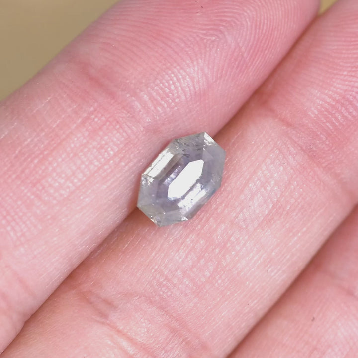 Rotating loose 2.40 carat gray purple Montana sapphire showing reflective planes and depth in the octagonal tablet cut.