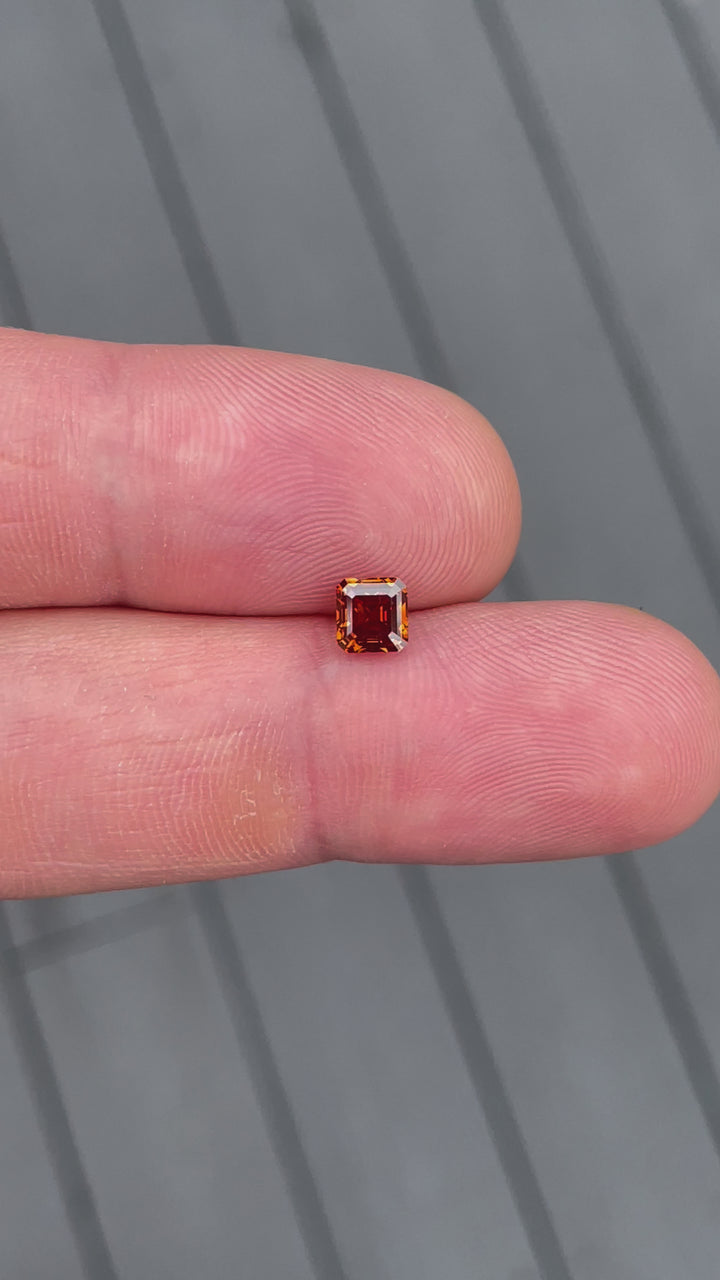 A mesmerizing video of a 1.01-carat cognac red diamond, showing its sparkle and warm cognac hues as it moves under natural lighting.