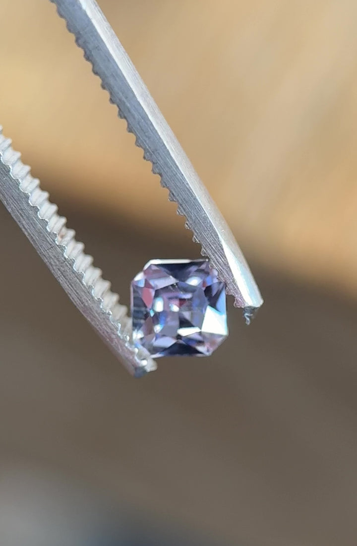 Close-up video of 0.67ct square radiant sapphire from Umba River – natural untreated gem showing vivid lilac and blue hues under shifting light