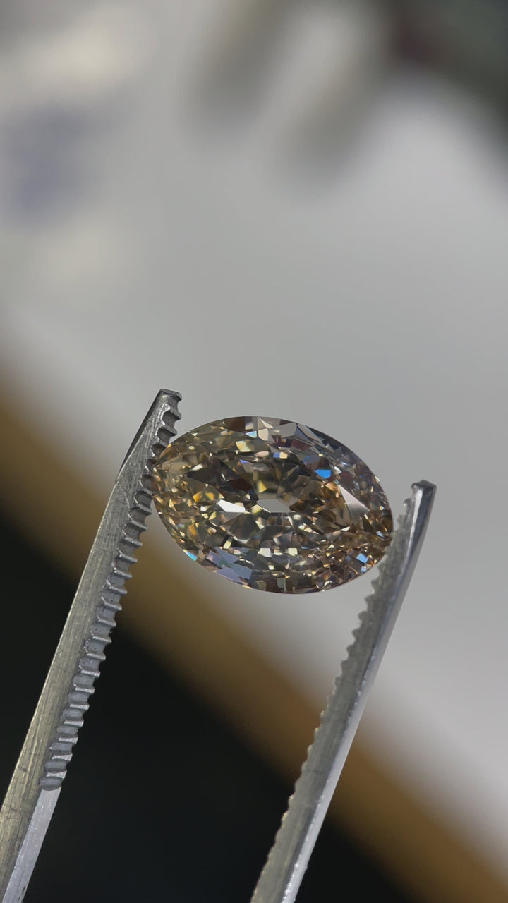 A close-up rotating video of a 3.01-carat fancy light brown champagne diamond, displaying its exquisite old mine moval cut and exceptional clarity from multiple angles.