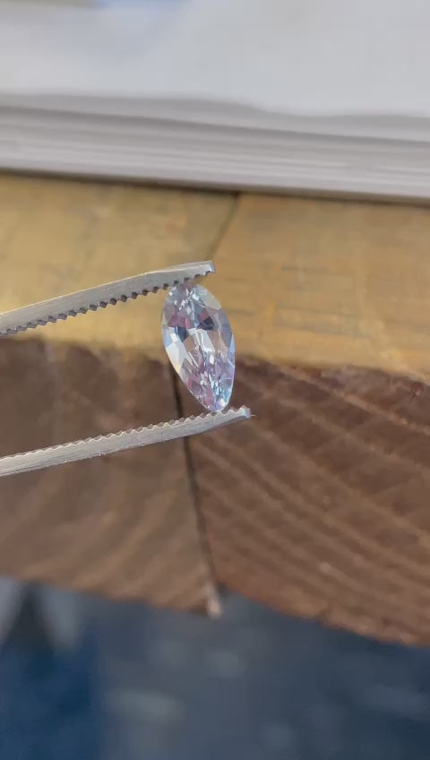 Detailed video exploration of a Sri Lankan light sage green sapphire, showcasing its 1.42 carat weight and custom modified pear shape. The untreated gemstone is rotated to display its dimensional properties and exquisite cut.