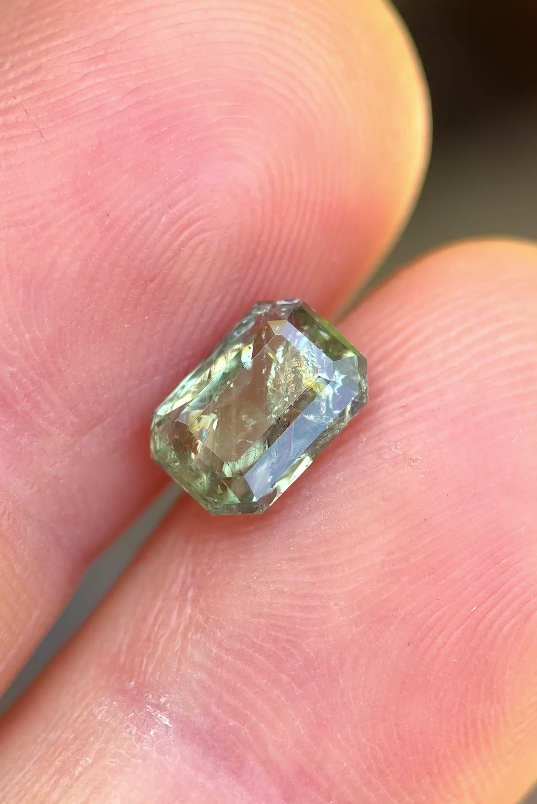 Macro video of glittering 2.06 carat unheated sapphire, showing color play and step facets from all angles