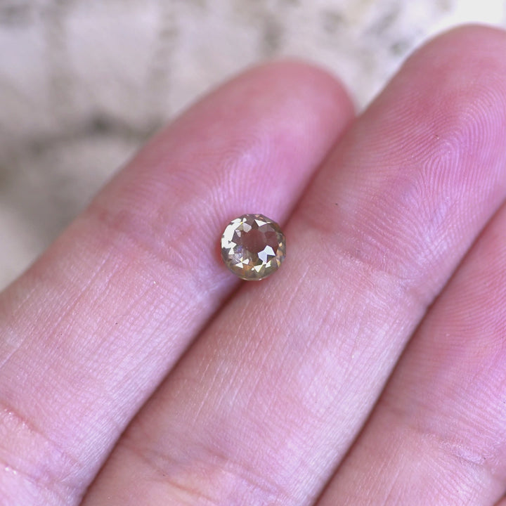 1.04ct Mughal diamond shown on hand displaying antique faceting, champagne tones, and blue fluorescent flashes