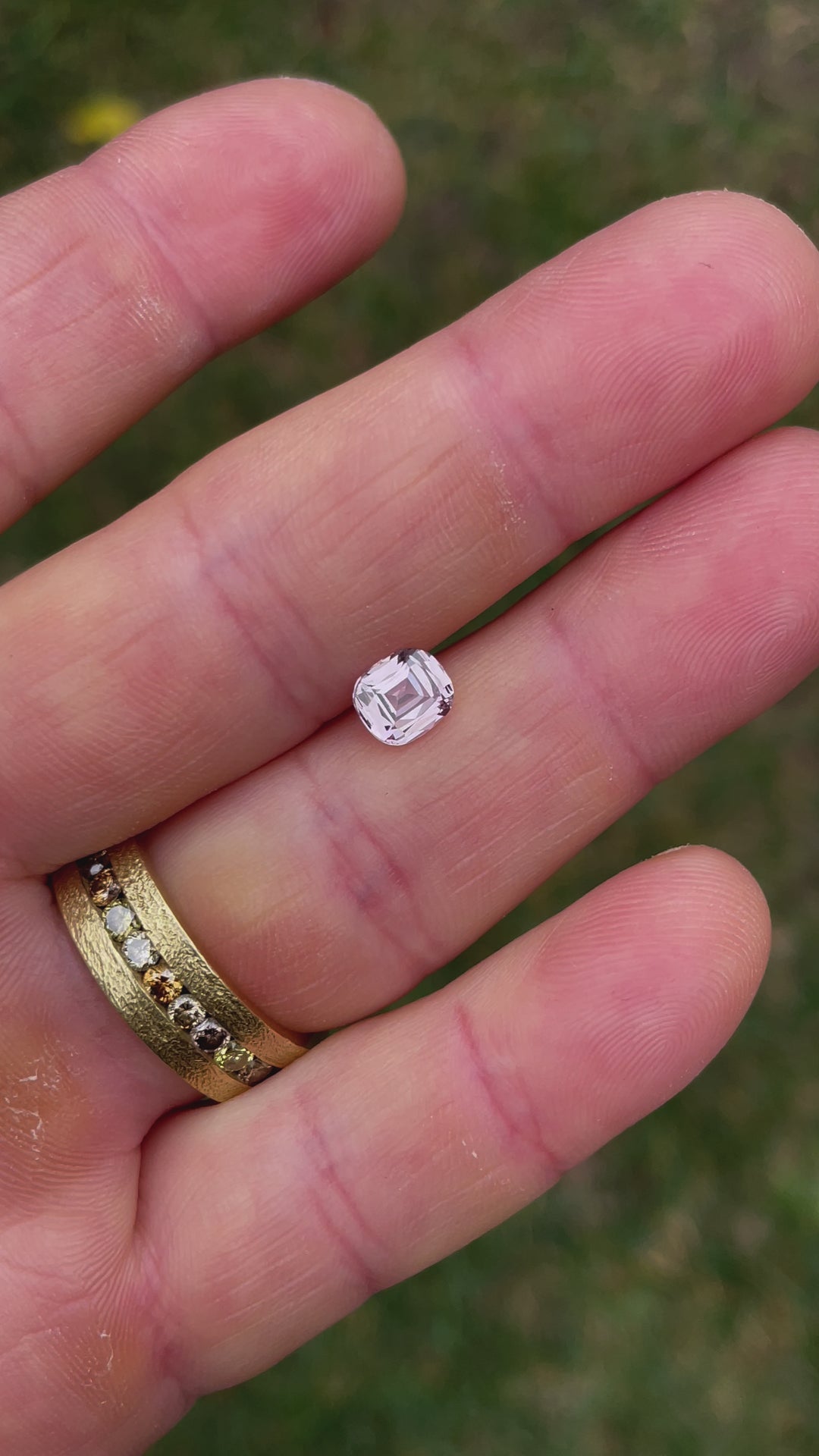 Video showcasing a 1.19-carat sapphire in pastel yellow and peach tones. The gemstone features a cushion modified cut, dimensions 6.57 x 5.79 x 3.47 mm, and originates from Sri Lanka. This untreated stone offers a soft and elegant color palette.