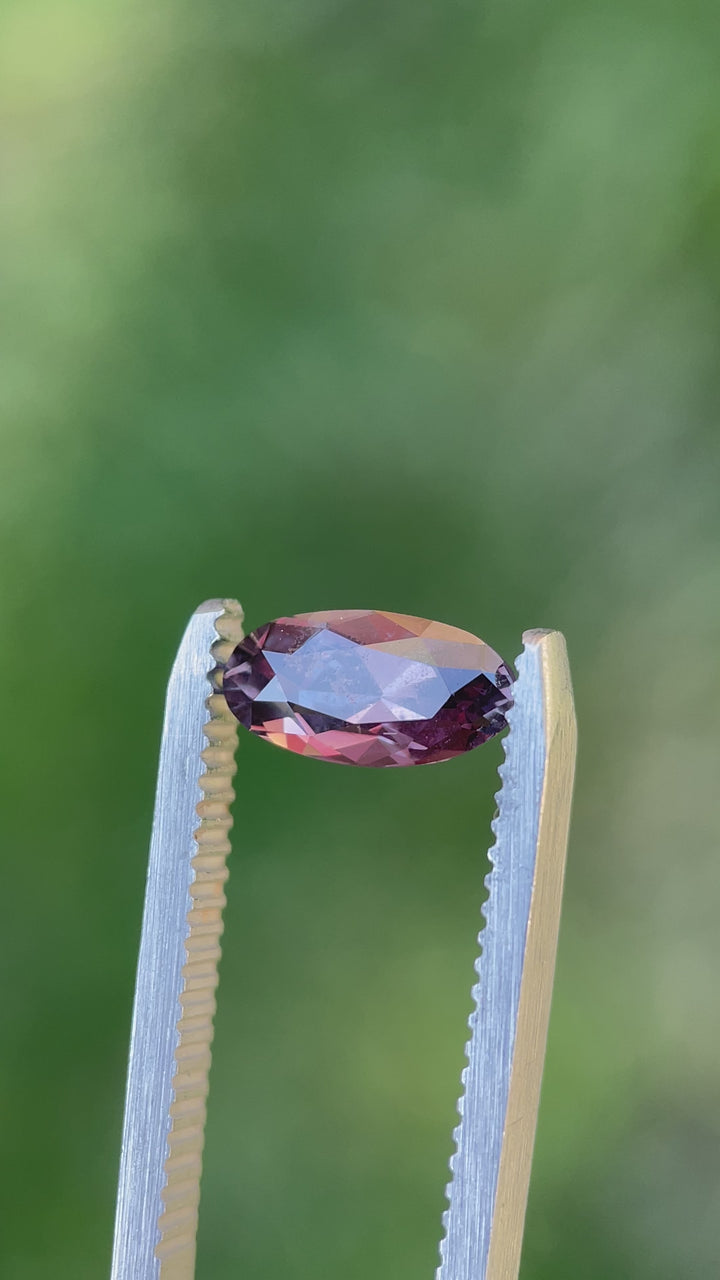 Rotating video of a 1.63-carat sapphire with dusty rose and mauve tones, showing luster and clarity in natural light. Cut in Moval shape from Umba River, Tanzania.