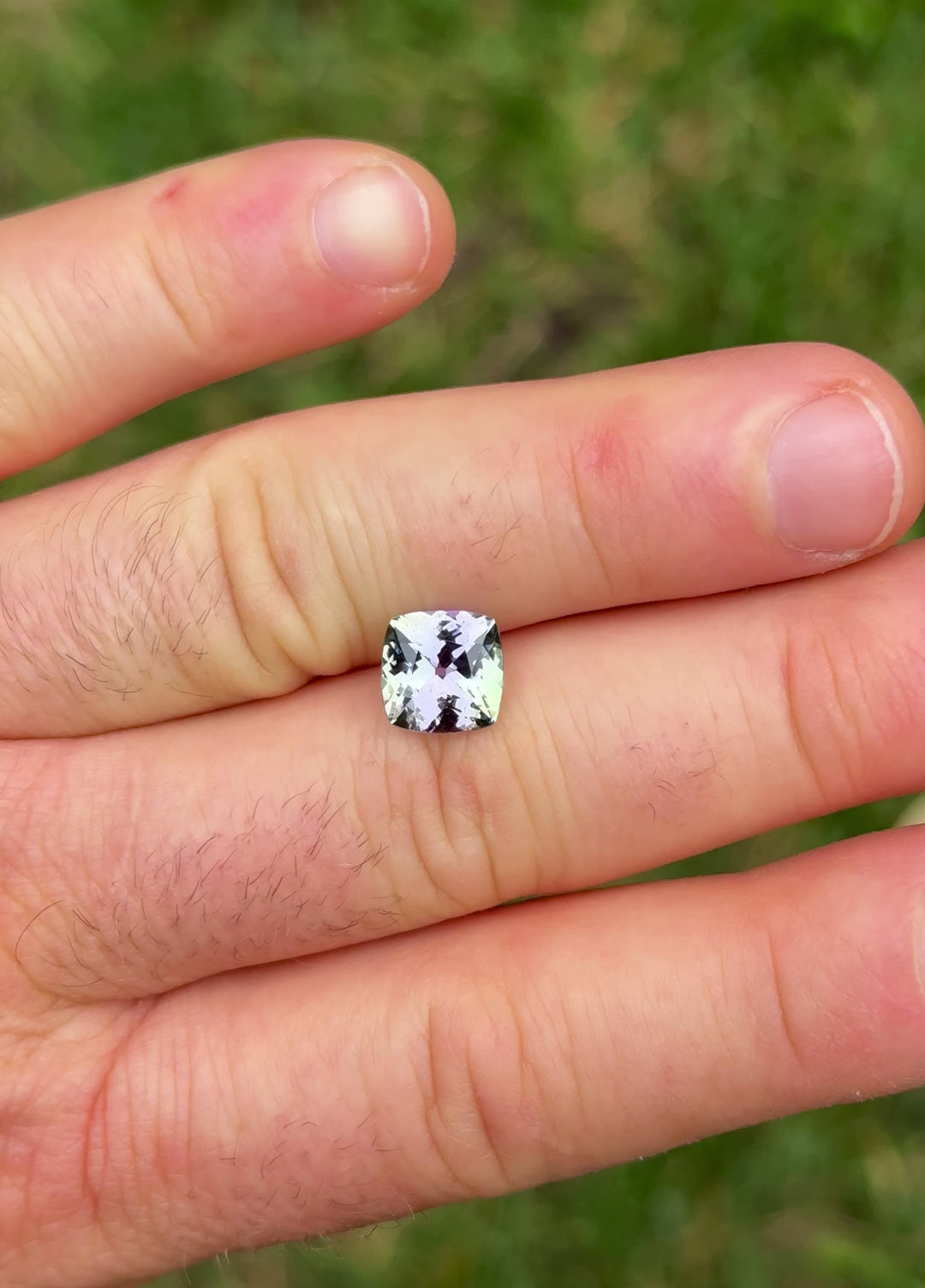 Natural Tanzanite video showcasing color play between green and purple hues in 3.13 carat cushion cut gem