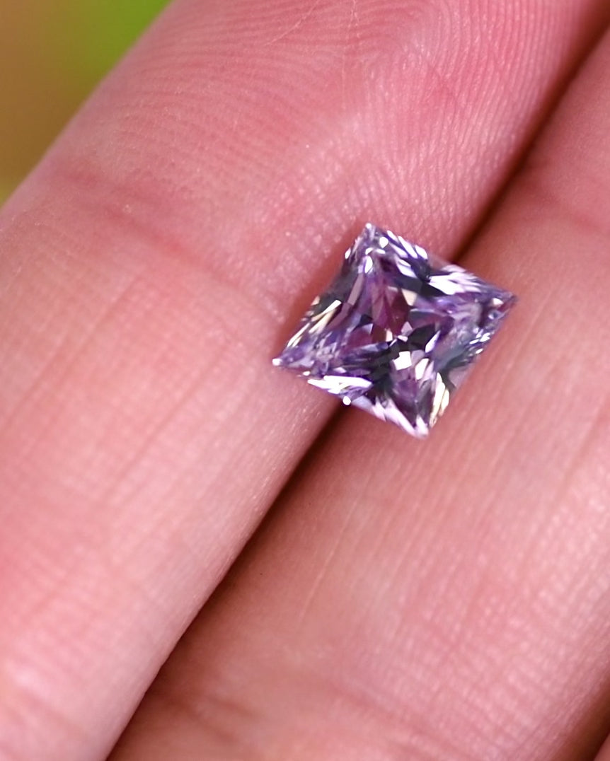 Video of 2.15 carat lavender gray sapphire shown on fingertip under daylight, moving to showcase pastel color shifts and the detailed faceting of the custom kite cut, untreated sapphire from Sakaraha, Madagascar.