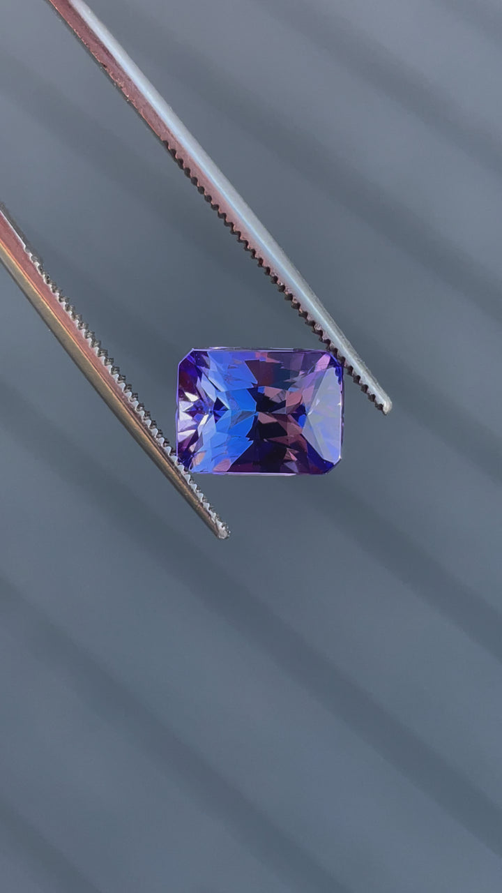 Detailed video showcasing a 3.57-carat Tanzanite gemstone, radiant cut, with captivating blue and ultra violet hues.