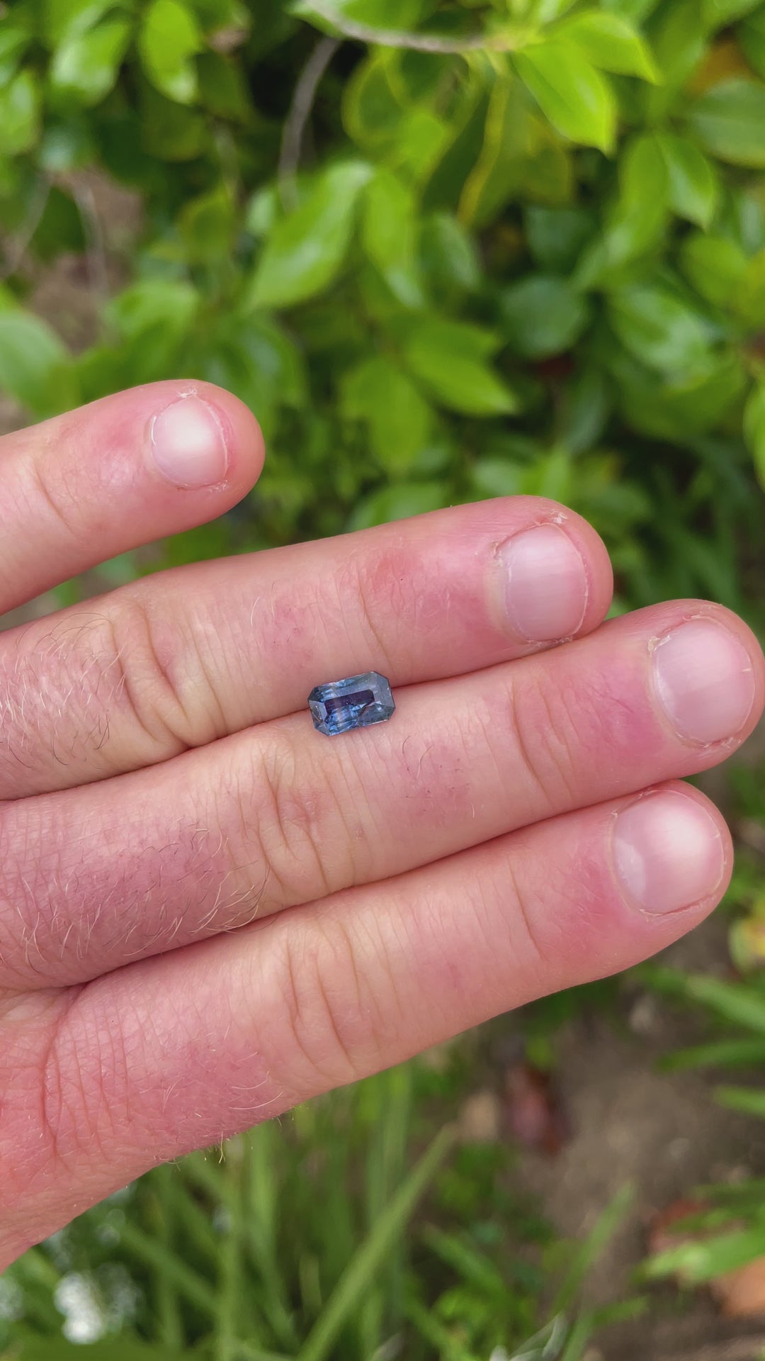 A video featuring a 1.45-carat teal and blue parti sapphire viewed under natural light, emphasizing its cut and play of colors.
