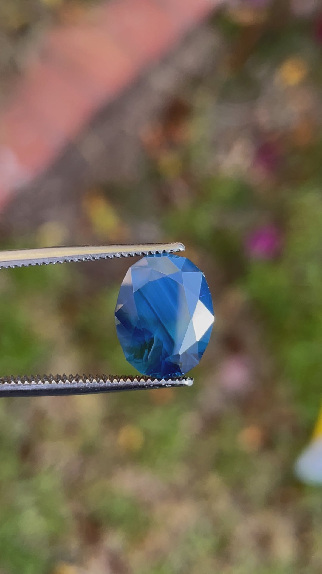 Video of a 5.23 carat oval sapphire, showing off its vibrant blueberry, green, and teal colors, from Gombe, Nigeria.