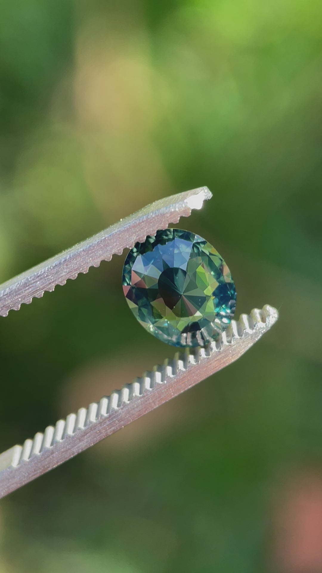 A 360-degree video showcasing the brilliance and color dynamics of a 1.72-carat mix cut oval sapphire. The gemstone features vibrant green, blue, and teal tones, untreated and ethically sourced from Madagascar.