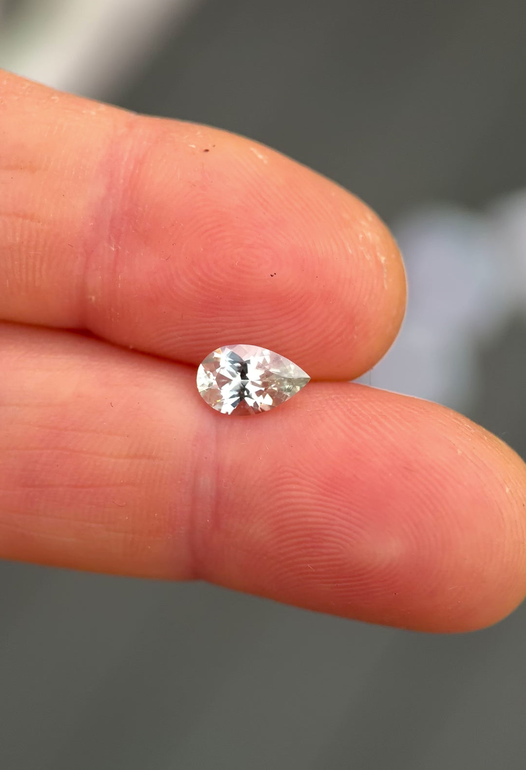 Hand-rotated video of a 1.13 carat Montana sapphire pear cut, showing natural silver seafoam color shifts, facet symmetry, and untreated brilliance as the gemstone catches light from multiple angles.