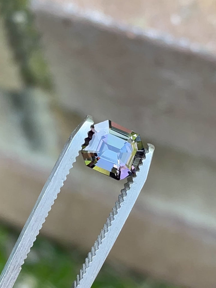 360-degree video of a 1.32 carat Tanzanite in emerald cut, showcasing vivid mermaid hues of teal, purple, and blue from Merelani Hills, Tanzania.
