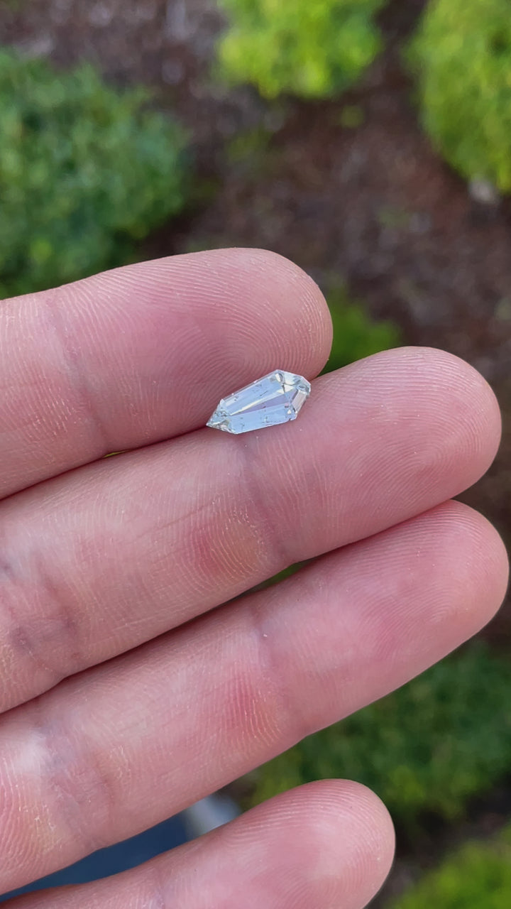 A high-resolution video displaying a 1.90-carat pale seafoam sapphire, revealing its precision step cut and natural brilliance from various angles.