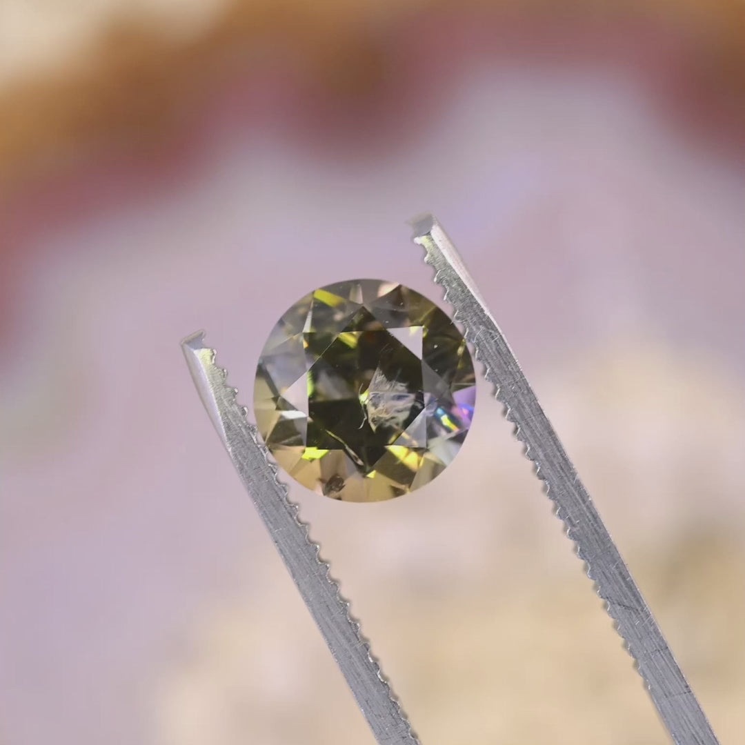 Close-up video of a 2.33 carat Tanzanite showing sparkle and depth as it moves, displaying antique round transitional brilliant faceting and vibrant multicolor hues from Merelani Hills
