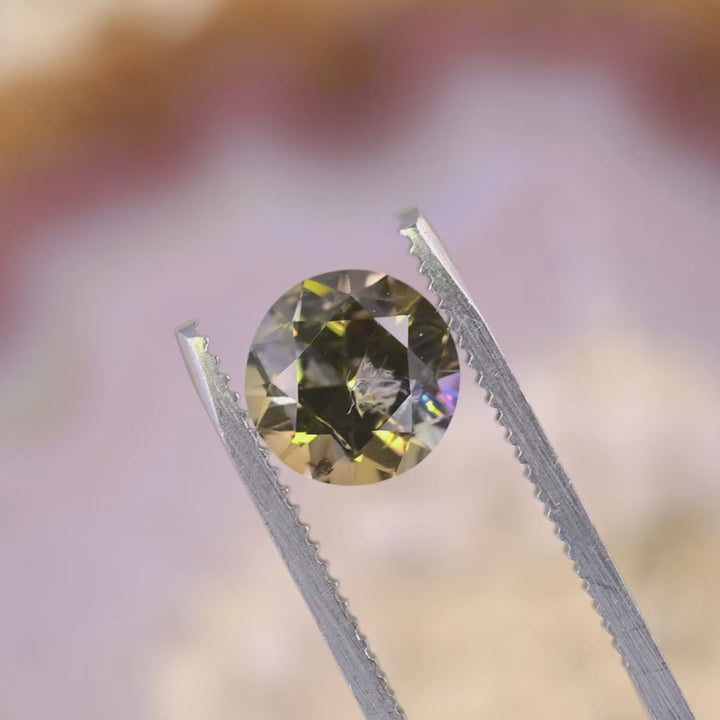 Close-up video of a 2.33 carat Tanzanite showing sparkle and depth as it moves, displaying antique round transitional brilliant faceting and vibrant multicolor hues from Merelani Hills