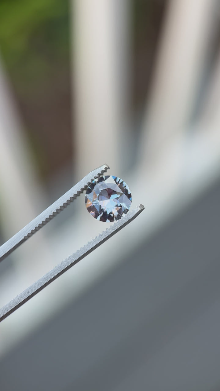 Macro video showing the grey-to-violet color change of a 2.60-carat sapphire as lighting shifts, highlighting its precision antique transitional round cut brilliance.