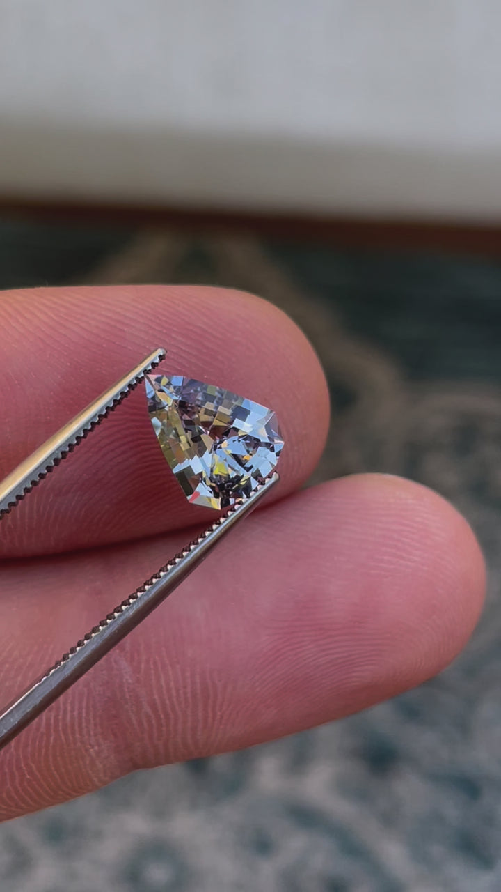 Detailed Video of a Custom Modified Shield Cut Sapphire Gemstone Exhibiting Color Shift from Pale Lavender to Pale Blue, Weighing 2.44 Carats, with Dimensions 10.33 x 8.17 x 4.76 mm, from Sri Lanka - No Heat Treatment