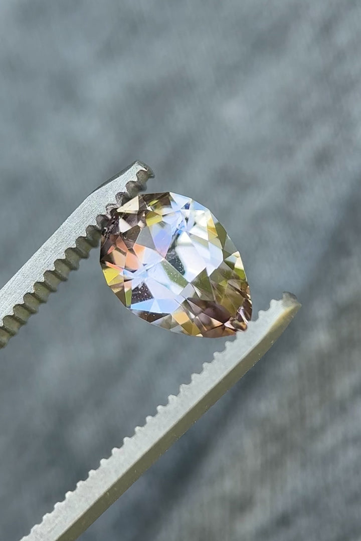 Rotating video of 2.19ct Tanzanite showing brilliant play of peach, purple, and blue hues in natural light