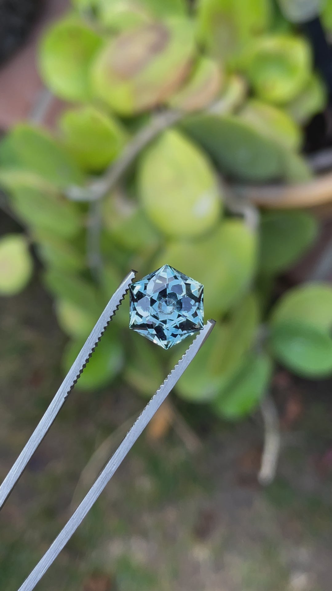 Interactive video showcasing the handling of a 5.79-carat hexagonal modified brilliant sapphire, emphasizing the gem's size, unique cut, and the vibrant hues of green and blue.