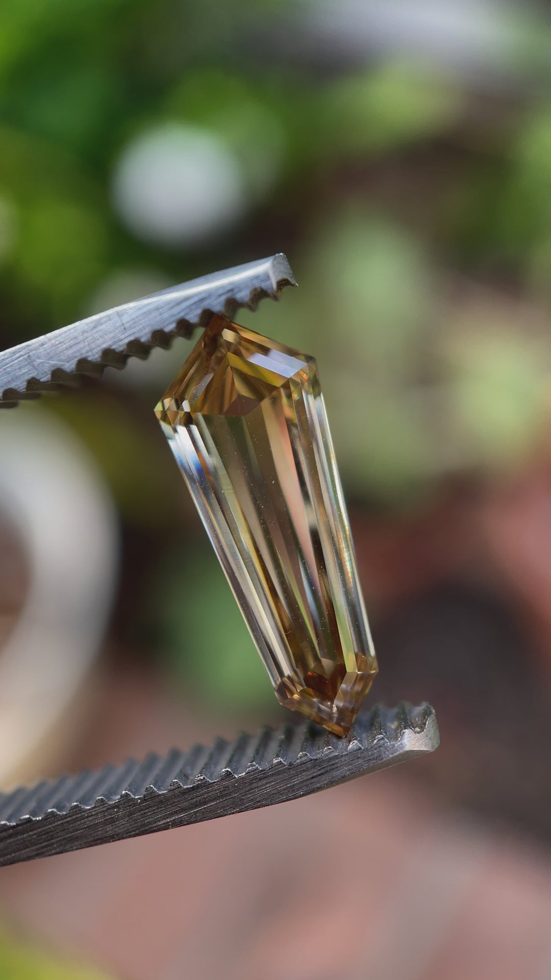 A natural light video of a 2.02-carat shield-cut champagne diamond, revealing its depth, clarity, and shimmering facets from multiple angles.