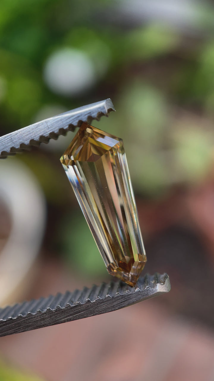 A natural light video of a 2.02-carat shield-cut champagne diamond, revealing its depth, clarity, and shimmering facets from multiple angles.