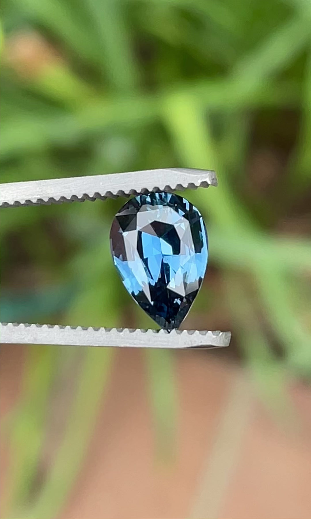 2.54 carat unheated pear brilliant sapphire from Madagascar shown in rotating natural light, highlighting teal, blue, and green tones.
