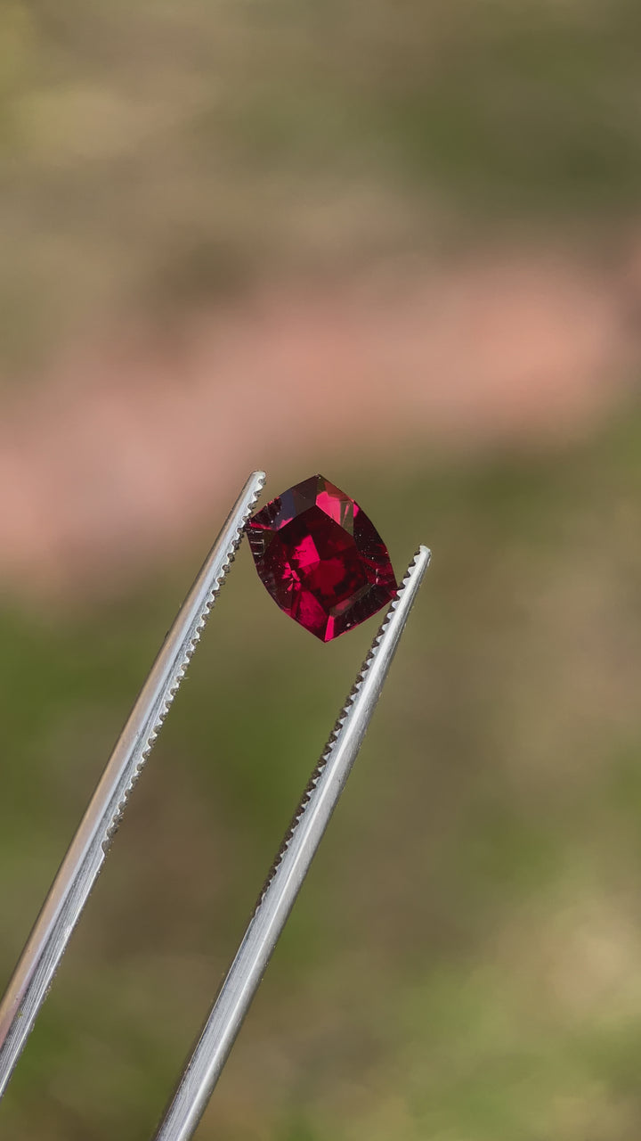 Detailed video highlighting the brilliance and cut of a 1.97 carat red-purple garnet gemstone from Mombo, Tanzania.