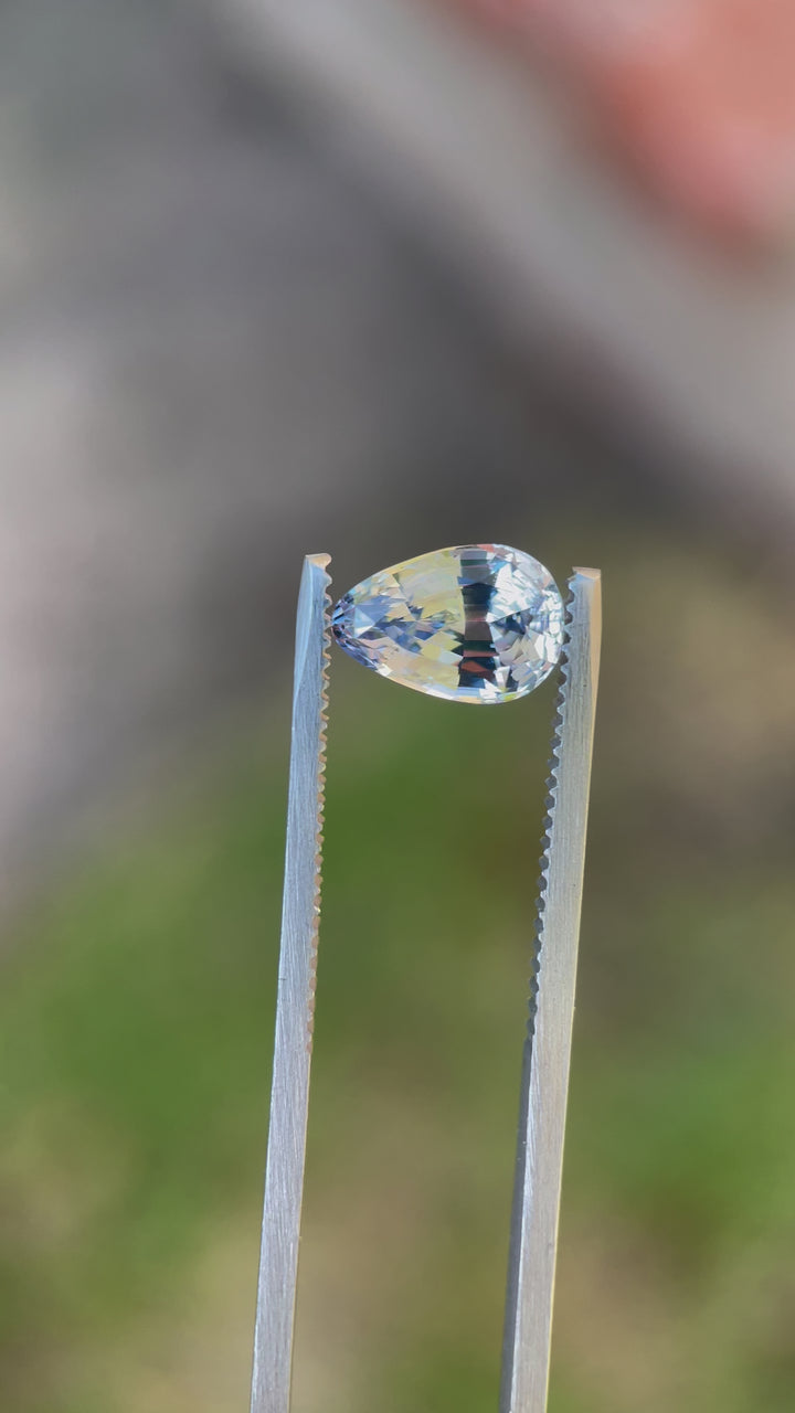 A sparkling video presentation of a 2.39-carat sapphire in cornflower and powder blue hues. The gemstone, crafted in a custom mix brilliant tear drop shape, boasts a natural, untreated origin from Sri Lanka.