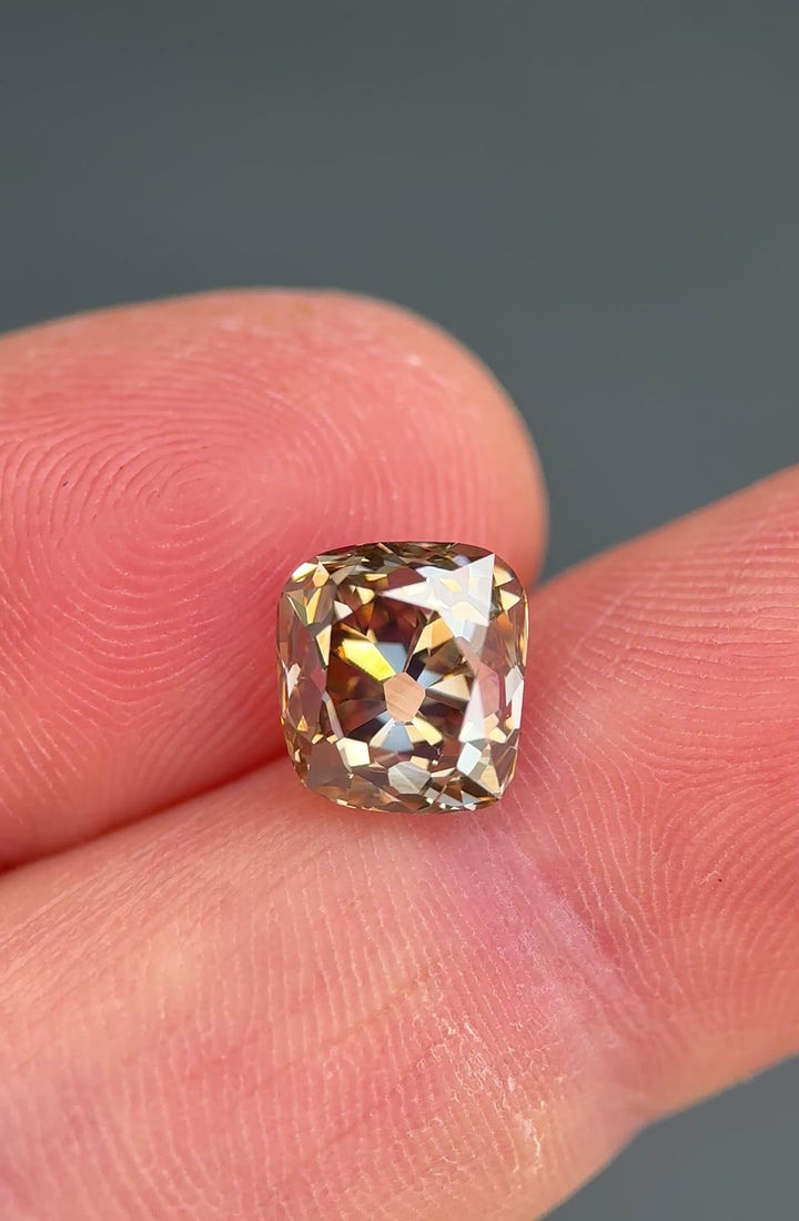 Close-up video of a 3.93 carat untreated Ekati Mine champagne diamond rotating slowly to reveal brilliance, symmetry, and warm cognac flashes throughout the stone.